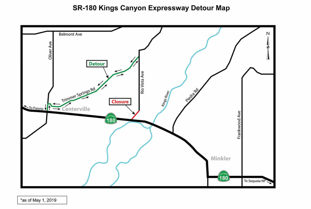 Map titled 'SR-180 Kings Canyon Expressway Detour Map,' showing a detour around a road closure near Rio Vista Avenue as of May 1, 2019. The closure is marked with a red line where Rio Vista Avenue intersects with State Route 180. The detour route is indicated in green along Trimmer Springs Road, bypassing the closure. Key landmarks include Centerville to the west, Minkler to the east, the Kings River, and nearby roads such as Piedra Road, Belmont Avenue, and Frankwood Avenue. North is indicated with a compass rose in the upper-right corner.