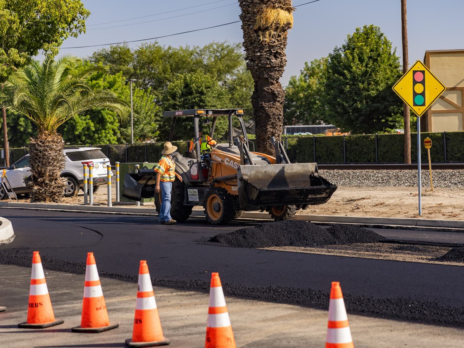 Photo of construction workers performing street repairs.